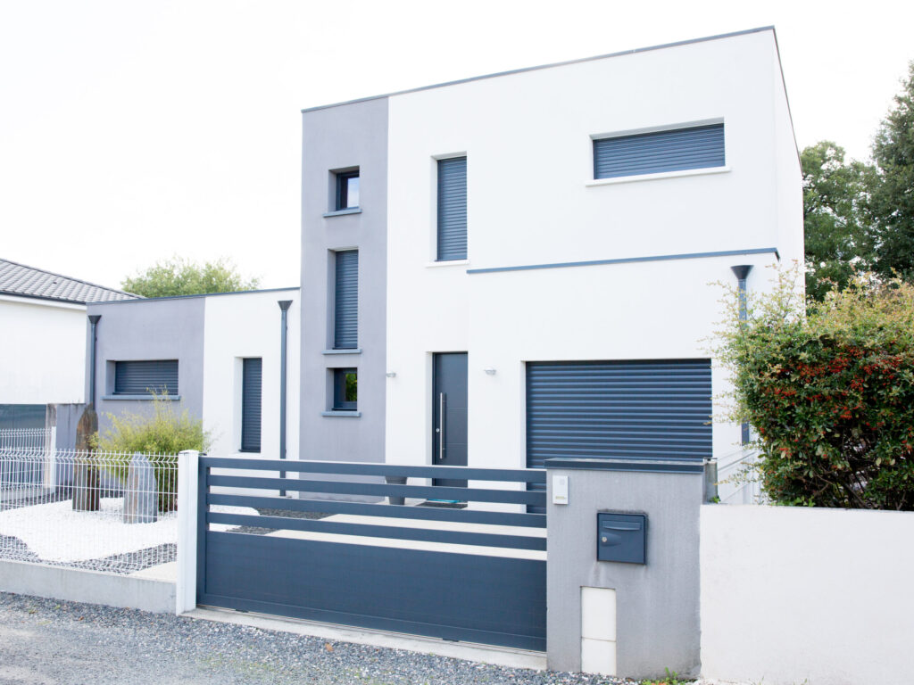 Modern house has a beautiful lawn in front of the house and garage from the left side that has concrete yard